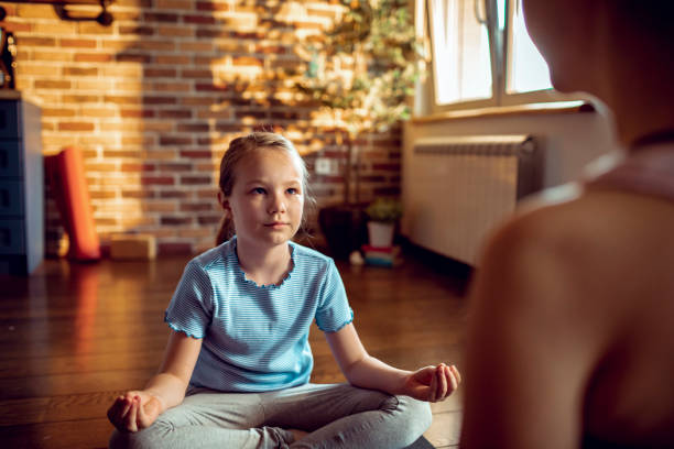istock Mother and Daughter doing Yoga 1249818695