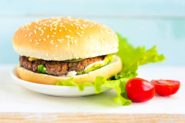 Classic cheeseburger on wooden background, closeup.