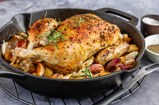 Roasted Whole Chicken on a Cast Iron Skillet Close-Up Low Angle Photo
