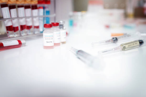 istock Sample of coronavirus vaccine (COVID-19) on work table in a medical lab. 1249820720