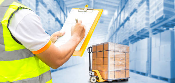 istock Warehouse worker holding clipboard checking checklist of shipment goods at the warehouse. 1249823857