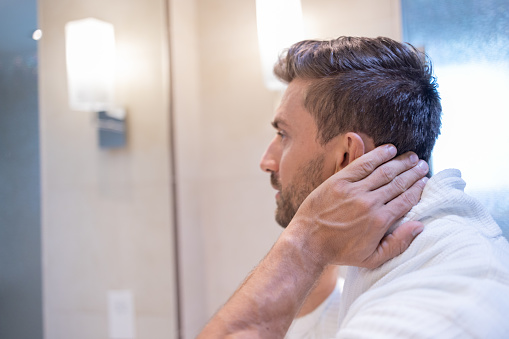 Caucasian Man After Shower Styling His Hair In The Bathroom Stock Photo -  Download Image Now - iStock