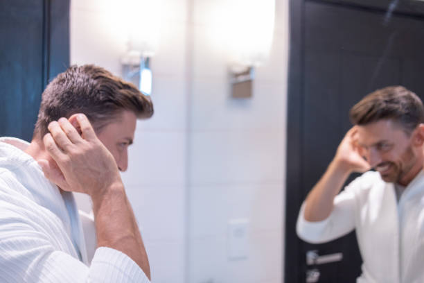 istock Caucasian man after shower looking at himself in the bathroom mirror 1249827609