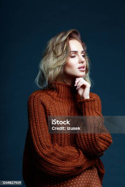 Fashion Portrait Of Elegant Woman In Brown Sweater Stock Photo - Download Image Now - Dark, Hand On Chin, Only Women