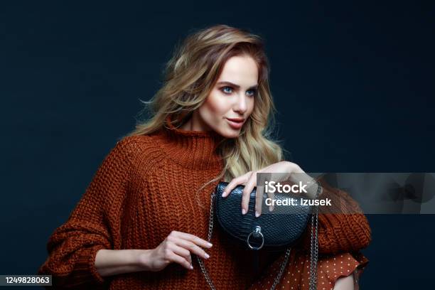Fashion Portrait Of Elegant Woman In Brown Sweater Dark Background Stock Photo - Download Image Now