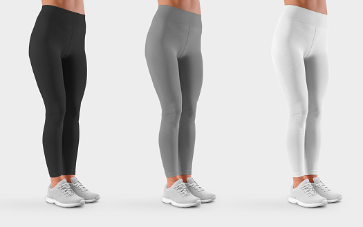 Mockup of black, white, gray leggings on a fit girl in sneakers, for presentation of design, front view. Template female pants isolated on background. Set of sportswear on a slim model