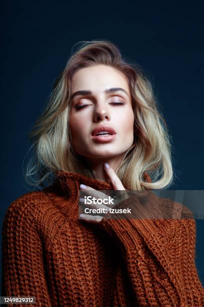 Headshot Of Blond Hair Woman In Brown Sweater Stock Photo - Download Image Now - Black Color, Fashion Model, Glamour