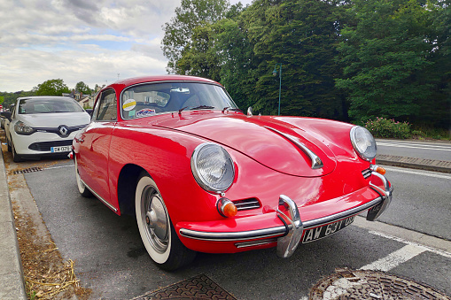 Münsingen, Germany - May 1, 2023: Porsche 911 930 Turbo Carrera german oldtimer vintage luxury sports car on a country road on a sunny summer day.