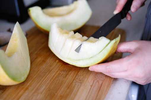 Woman cut melon