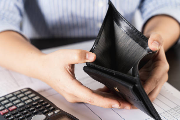 istock Poor Asian woman hand open empty wallet looking for money having problem bankrupt broke after credit card payday. Insolvency in the economy and finance. People have no money. 1249835156