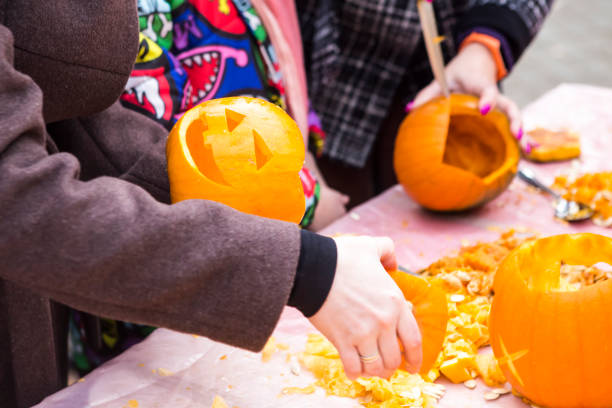 istock people are carving head pumpkin in the park 1249837584