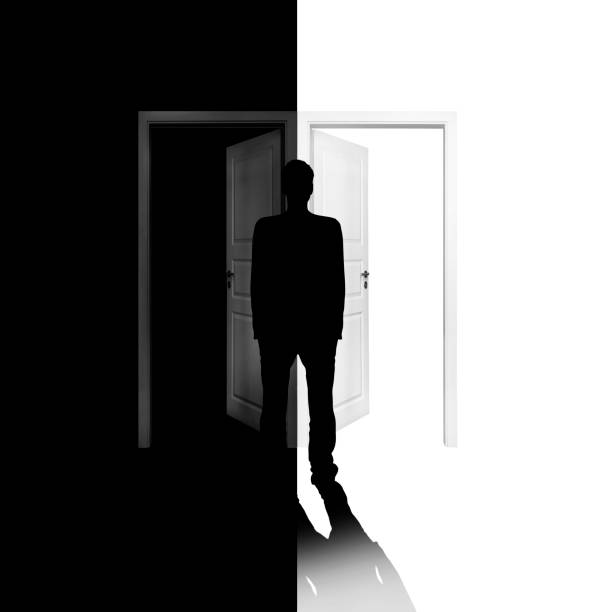 istock Choice between entering a black or white door 1249839089