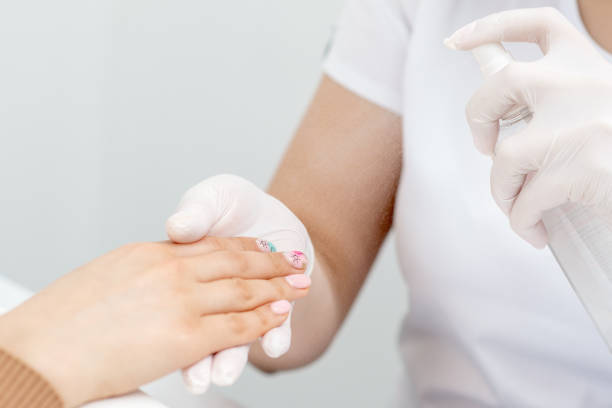 istock Manicurist is moisturising fingernails by thermal water. 1249839763