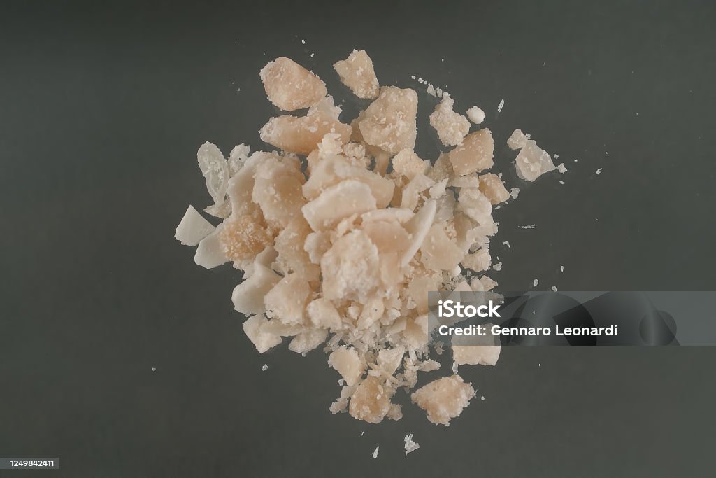 Crack cocaine street dosage Crack, a type of drug obtained through chemical processes from cocaine. Amazing substance in small pieces. Crack is produced by dissolving powdered cocaine in a mixture of water and ammonia or sodium bicarbonate (baking soda). The mixture is boiled until a solid substance forms. The solid is removed from the liquid, dried, and then broken into the chunks (rocks) that are sold as crack cocaine. The name "crack" refers to the sound generated during its manufacture and when smoked. Street names include: rock, hard, iron, cavvy, base, or just crack. Crack Cocaine Stock Photo
