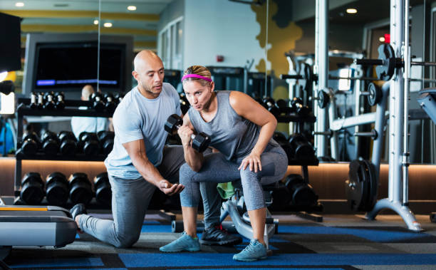 istock Hispanic woman personal trainer in gym 1249842968