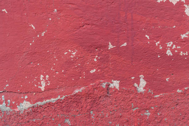 istock Old concrete red painted wall with unevenness and drips 1249845606