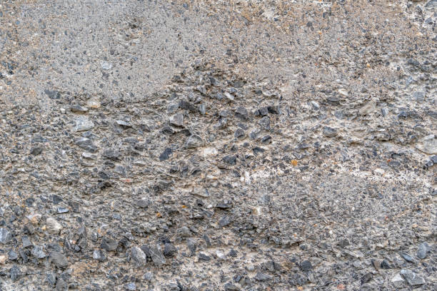 istock Old concrete destroyed wall with bumps and cracks 1249845654