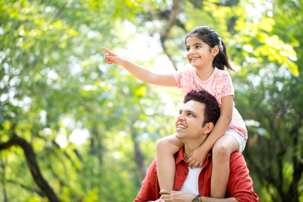 istock Father carrying daughter on shoulders 1249847511