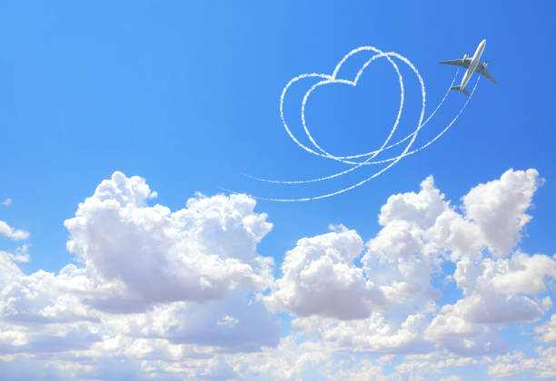 Aircraft draw a heart in the sky. Flight route of aircraft in shape of a heart. Love concept for traveling the world. Copy space for text