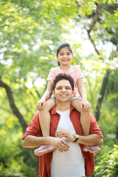istock Father carrying daughter on shoulders 1249849459