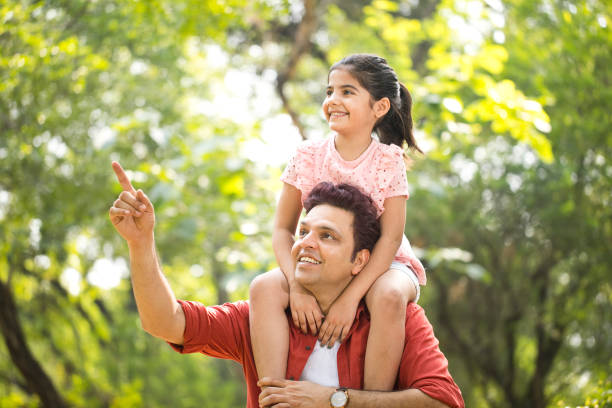 istock Father carrying daughter on shoulders 1249849473
