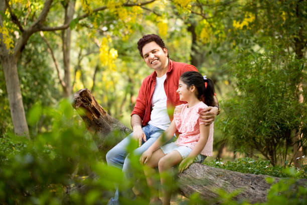 istock Father with daughter outdoors at park 1249849488