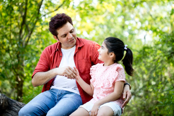 istock Father with daughter outdoors at park 1249849627