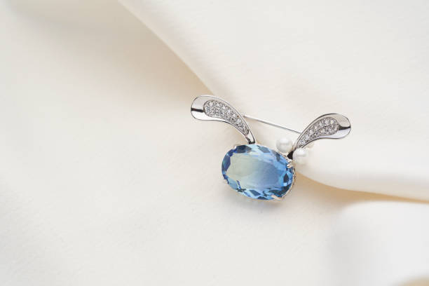 istock Silver brooch shaped like a hare with blue iridescent crystal 1249851321
