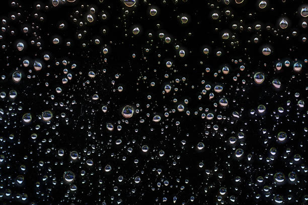 istock Rain drops on window with black background,Rainy day,Water drop on glass 1249851869