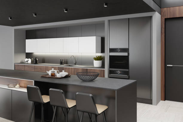 Luxurious matte black minimalist kitchen interior with long island table