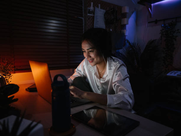 istock Freelancer girl works at laptop in evening 1249853215