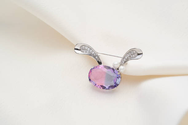 istock Silver brooch shaped like a hare with purple iridescent crystal 1249853227