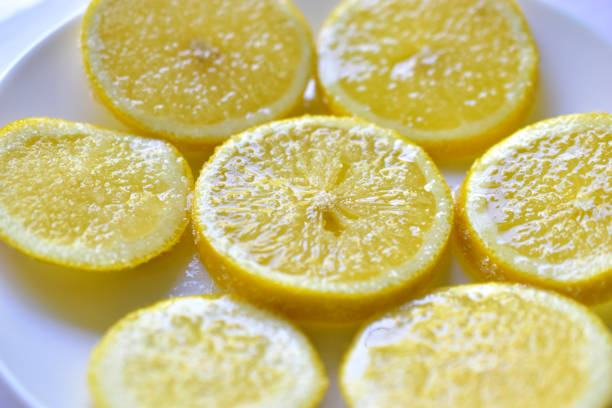 istock Yellow ripe lemons cut into slices on a white plate 1249854617