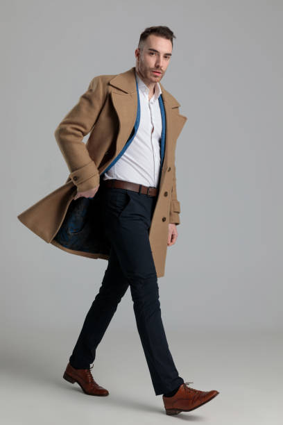 istock attractive smartcasual man adjusting long coat 1249855170