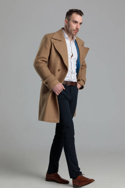 istock young smartcasual man wearing longcoat looking to side 1249855178