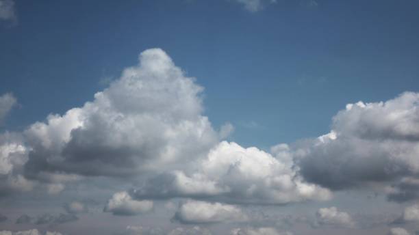 istock 4K Timelapse motion of white fluffy cumulus clouds on ablue sky background. 1249855198