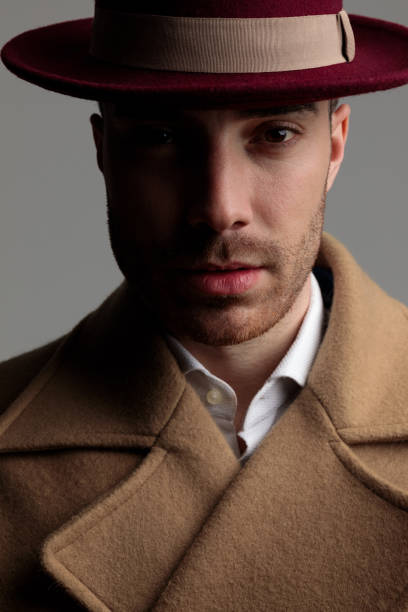 istock mysterious young guy wearing long coat and hat 1249855967