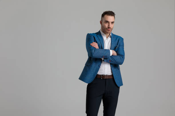 istock young smartcasual guy looking to side and crossing arms 1249856147