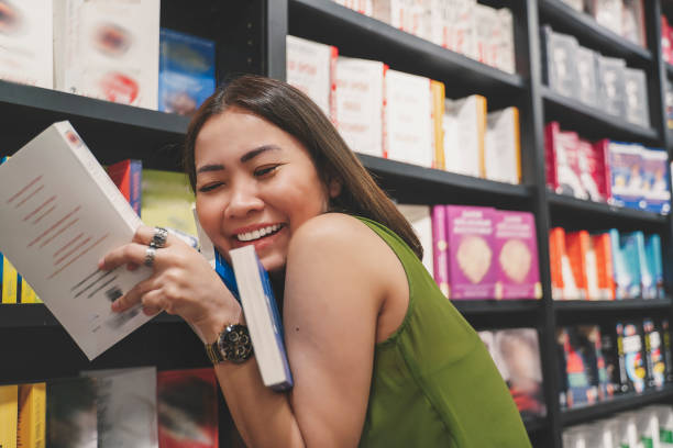 istock Female student searching books in the book store 1249856537