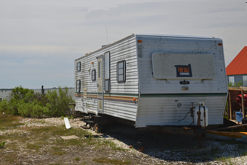 A well used camper sits gathering rust and mold waiting for a buyer to venture down to this remote location on Marylands Eastern Shore