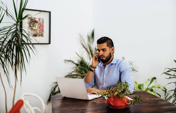istock Handsome businessman with beard and shirt working from home 1249858555
