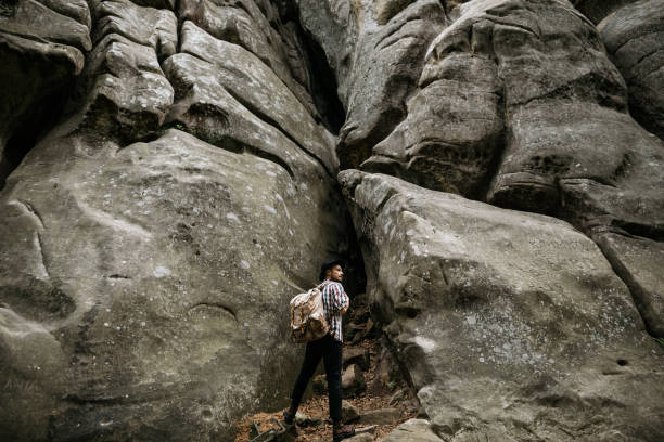 istock A hiker stands in front of a high cliff obstacle. Mountain tourism 1249860792