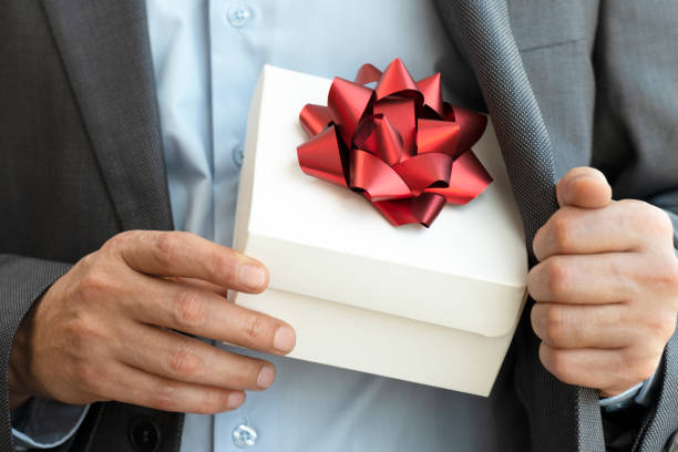 istock Businessman giving Gift Box 1249862268