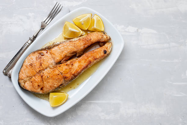 istock fried salmon with lemon on white dish on ceramic background 1249862290