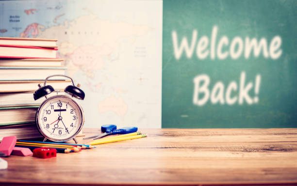 istock Alarm clock with back to school supplies in background. 1249864478