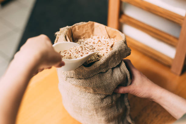 istock Scoop of raw brown rice 1249865990