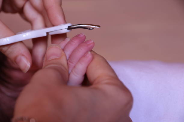 istock Cutting fingernails of newborn baby 1249866184