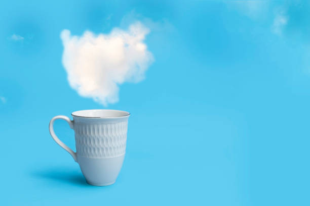 Morning coffee cup on beautiful blue sky with puffy clouds background and space for text