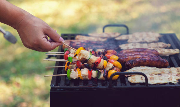istock Young woman preparing barbecue in the backyard 1249868062