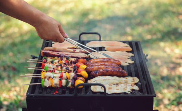 istock Young woman preparing barbecue in the backyard 1249868105